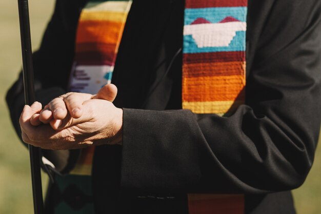 Priest holds his hands on each other during the wedding ceremony