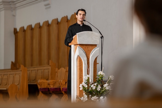 Free photo priest inside church building