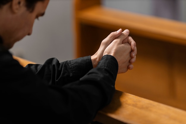 Free photo priest praying in church building