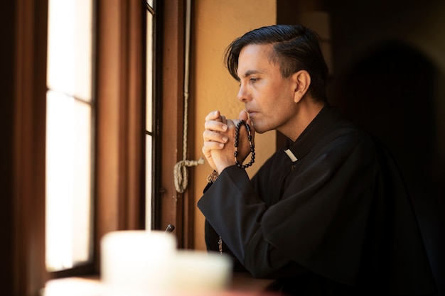 Free photo priest praying in church