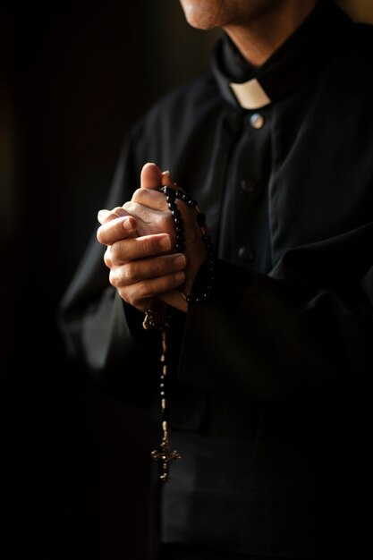 Priest praying in church