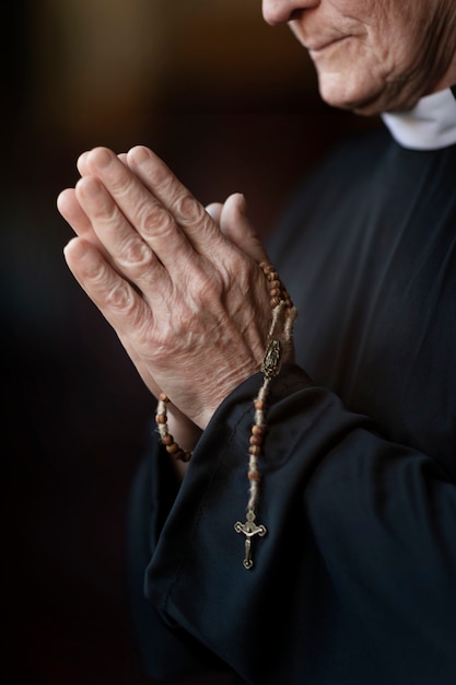 Priest praying in church