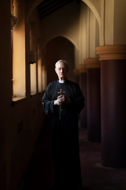 Priest praying in church