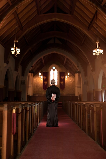 Priest praying in church