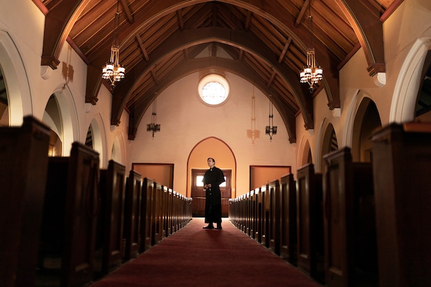 Free photo priest praying in church