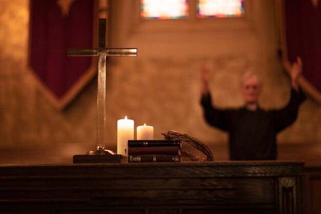 Priest praying in church