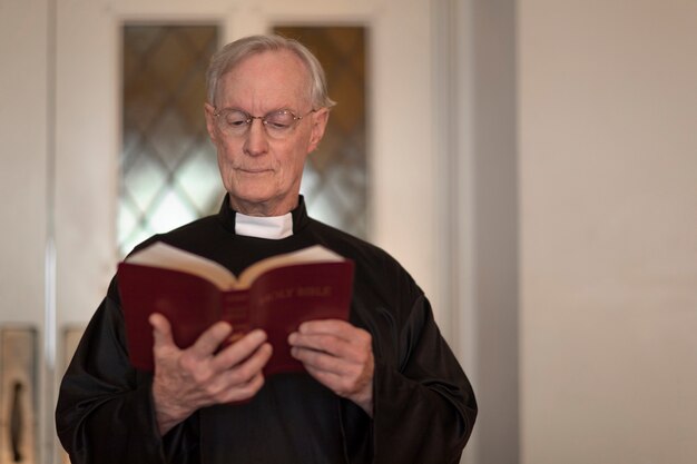 Priest reading from bible