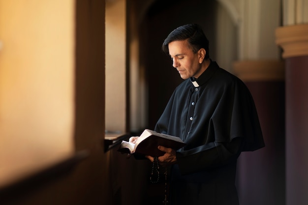 Free photo priest reading from bible