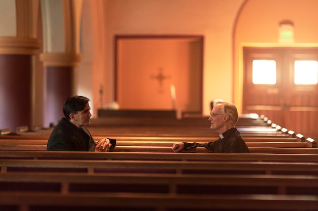 Priests praying together in church