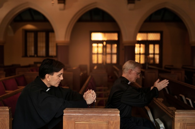 Free photo priests praying together in church