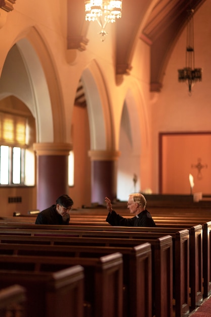 Priests praying together in church