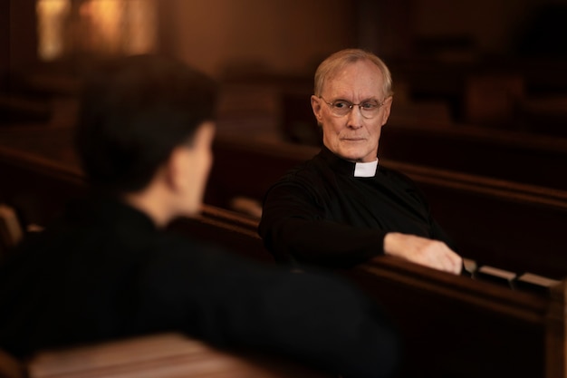 Free photo priests praying together in church