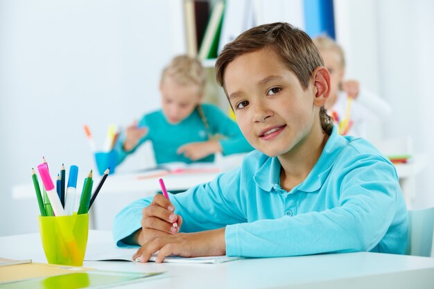 Primary student holding a pencil