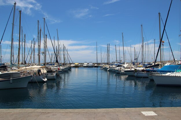 Private boats parked in the port under the pure blue sky