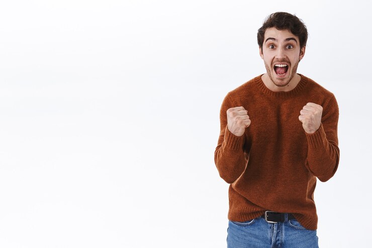 Free Photo prize, lottery and win concept. excited happy young man scream yes from success, achieve goal, fist pump