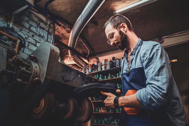 Process of creating new pair of shoes by experienced cobbler at his workshop.