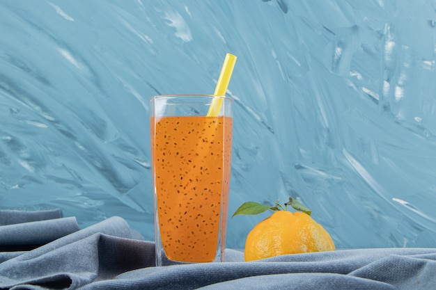 Processed juice and lemon,on the towel, on the blue background. High quality photo