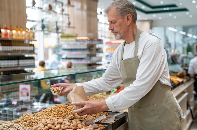 Producer at his shop with different goodies