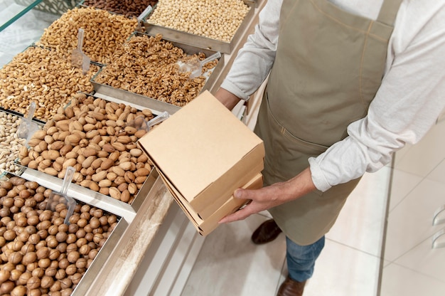 Producer at his shop with different goodies