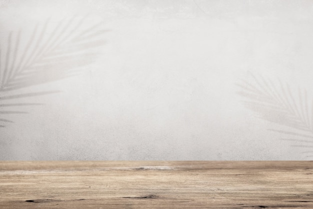 Product backdrop with empty wooden floor and tropical leaves shadow