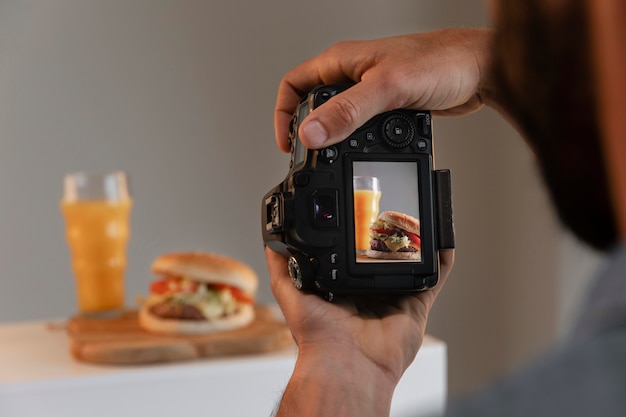 Product photographer with camera in studio