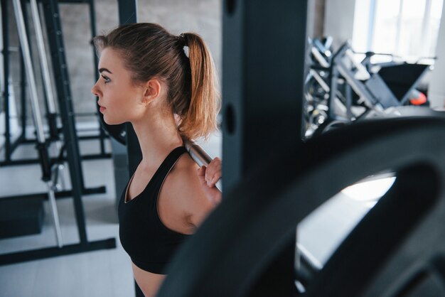 Productive free time spending. Photo of gorgeous blonde woman in the gym at her weekend