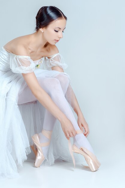 Профессиональная балерина надевает балетные туфли