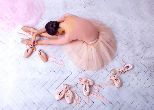 Professional ballet dancer resting after performance.