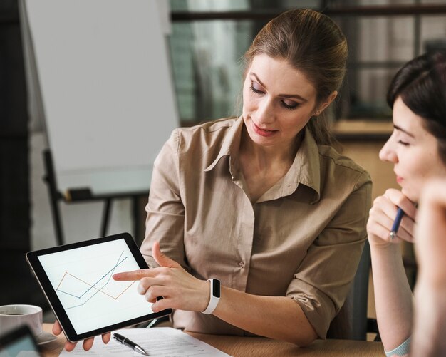 Professional businesspeople using tablet during a meeting indoors