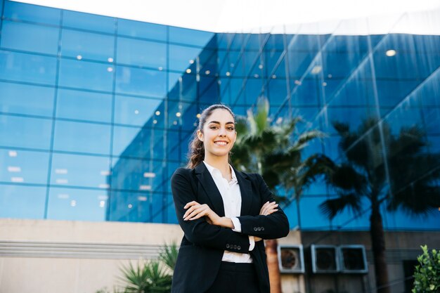 Professional businesswoman in front of modern building