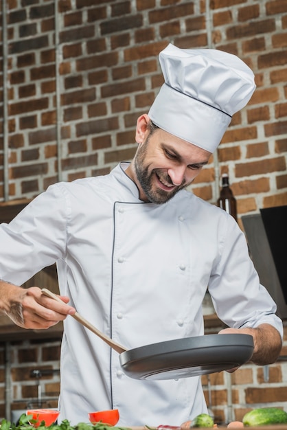 Professional chef in kitchen preparing food