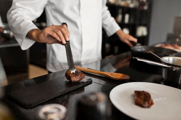 Free photo professional chef preparing food in the kitchen