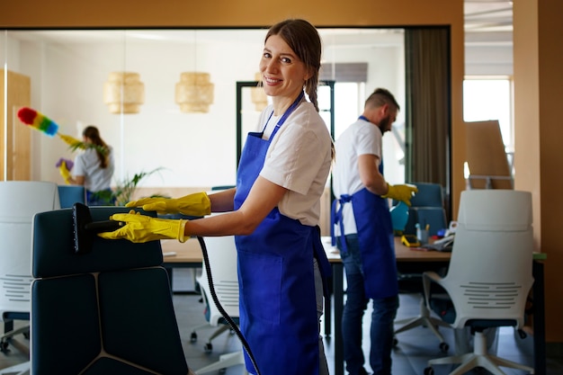 Professional cleaning service people working together in an office