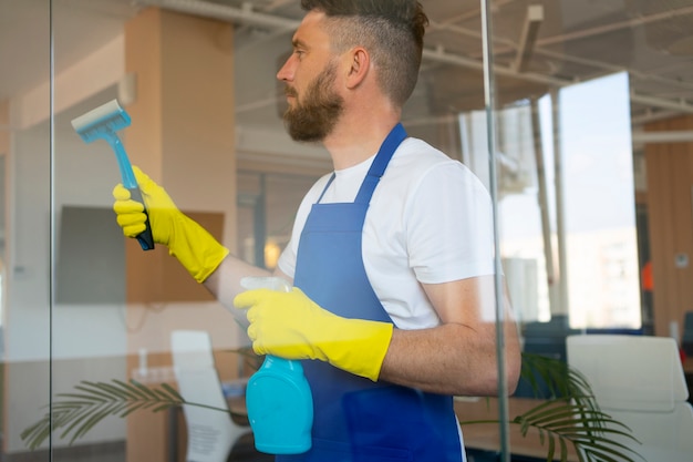 Free photo professional cleaning service person cleaning office window