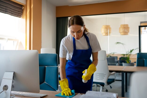 Professional cleaning service person cleaning office