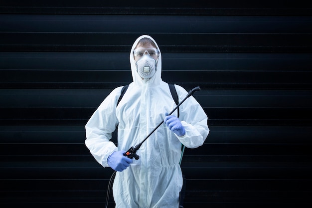 professional exterminator holding sprayer equipment for pest control
