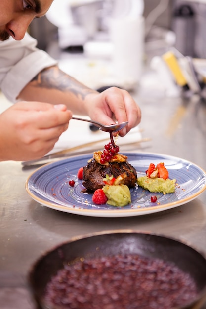 Professional food decoration in restaurant kitchen.Cook doing a great job