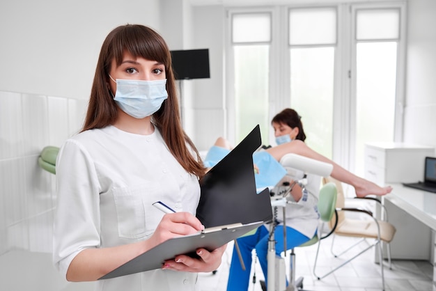 Professional gynecologist examining her patient