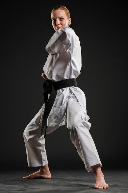 Free photo professional karate woman practicing full shot