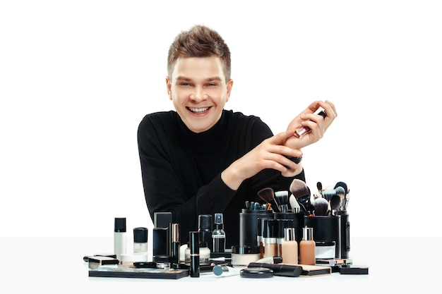 Free photo professional makeup artist with tools isolated on white . the man in female profession. gender equality concept