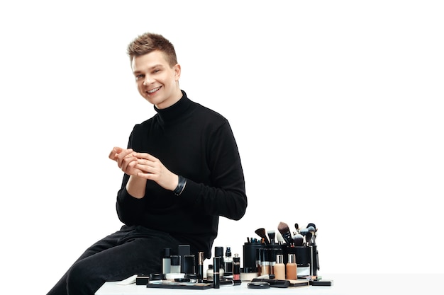 Professional makeup artist with tools isolated on white . The man in female profession. gender equality concept