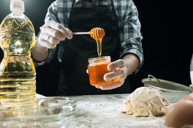 Professional male cook using honey to cook