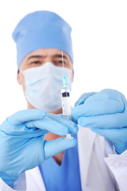 Professional male surgeon holding syringe with vaccine