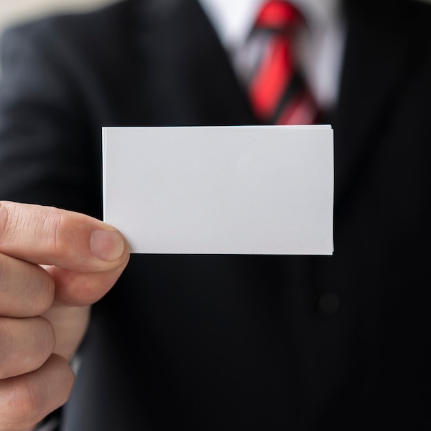 Professional man holding blank business card