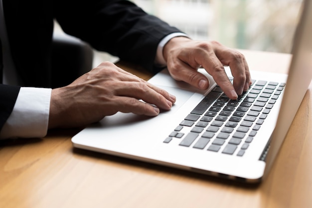 Professional man typing on laptop