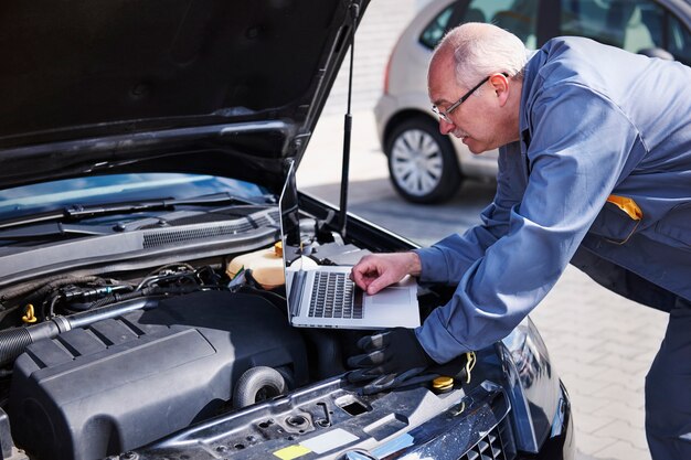 Professional mechanic using contemporary technology at work