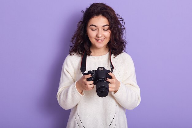 Professional photographer standing isolated over lilac