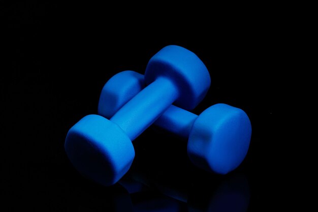 Professional sport equipment isolated on black. Black gym weights.