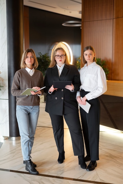 Free photo professional women in stylish suit at the office with tablet device