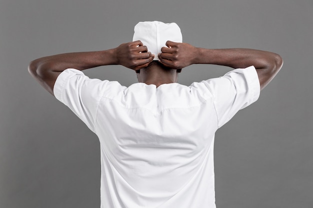 Free photo professional young doctor adjusting his medical cap